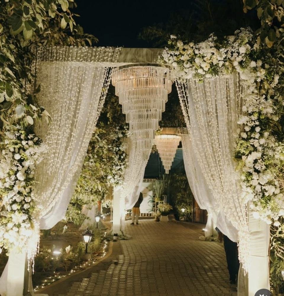 Floral chandelier entrance by candlelight