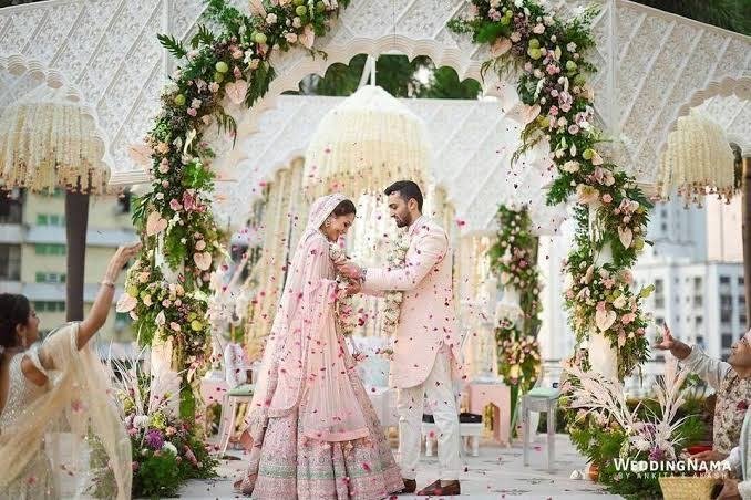 Couple under a floral mandap