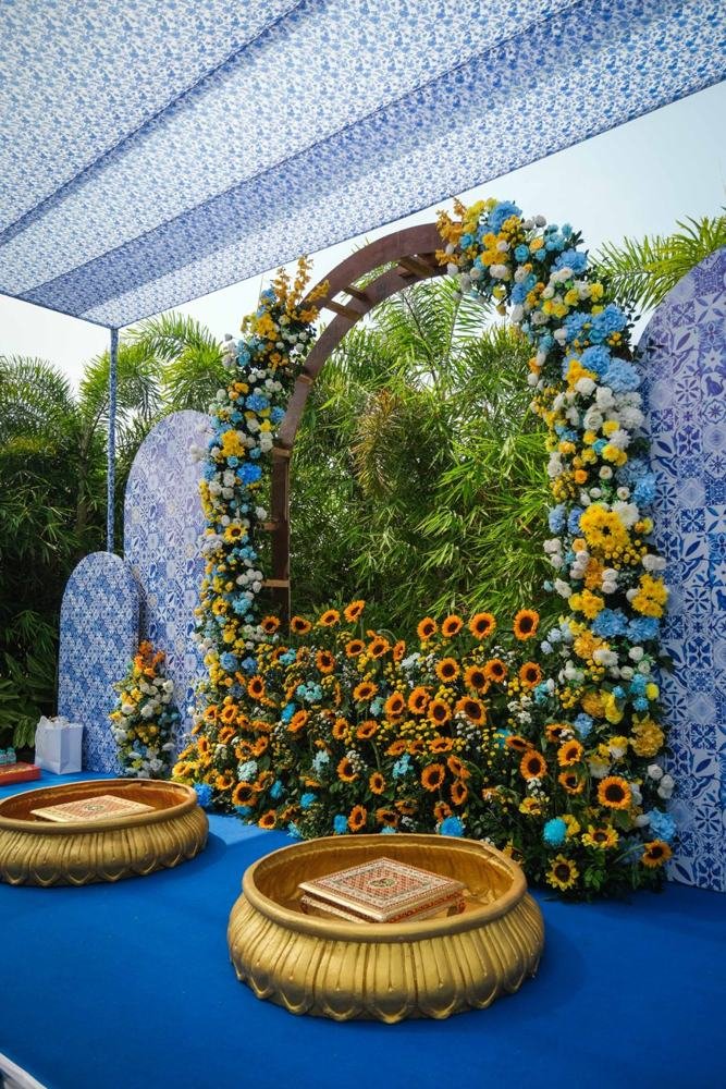 Sunflower arch with brass urli bowls