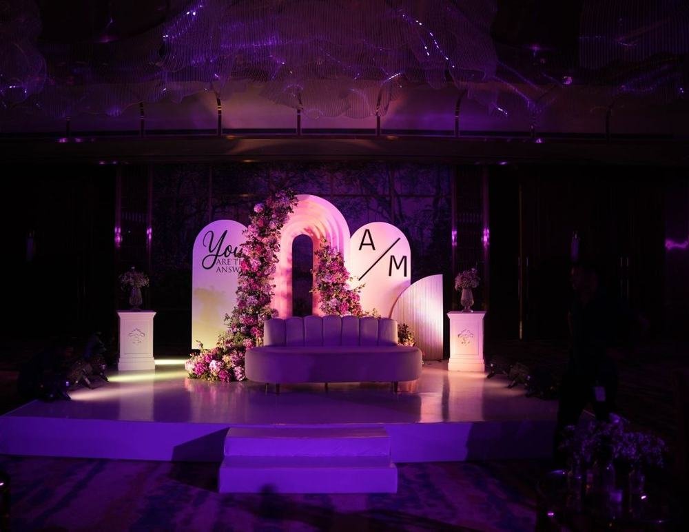 Monogram stage under purple light